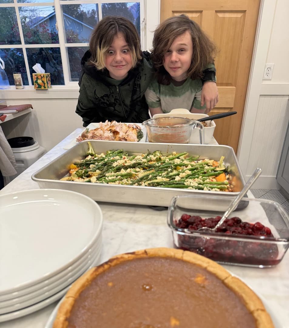 Alex and Griffin Still eye the feast before their family celebrated their first Thanksgiving after losing their home in Altadena.
