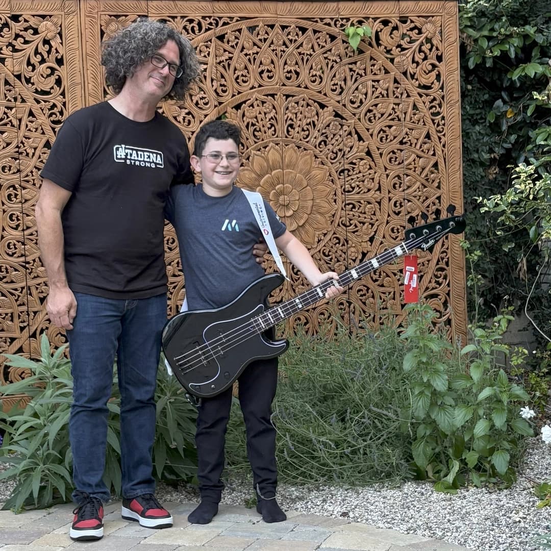 Brandon Jay, Altadena Musicians founder, with 13-year-old Hudson Marks and his new Duff McKagan bass.